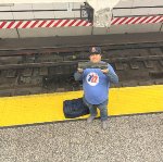 A subway fan holding up a model of an Arnine train while waiting for the real Arnine Set at 96th St Station